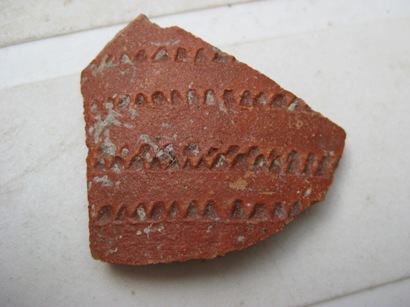 A decorated pot sherd.